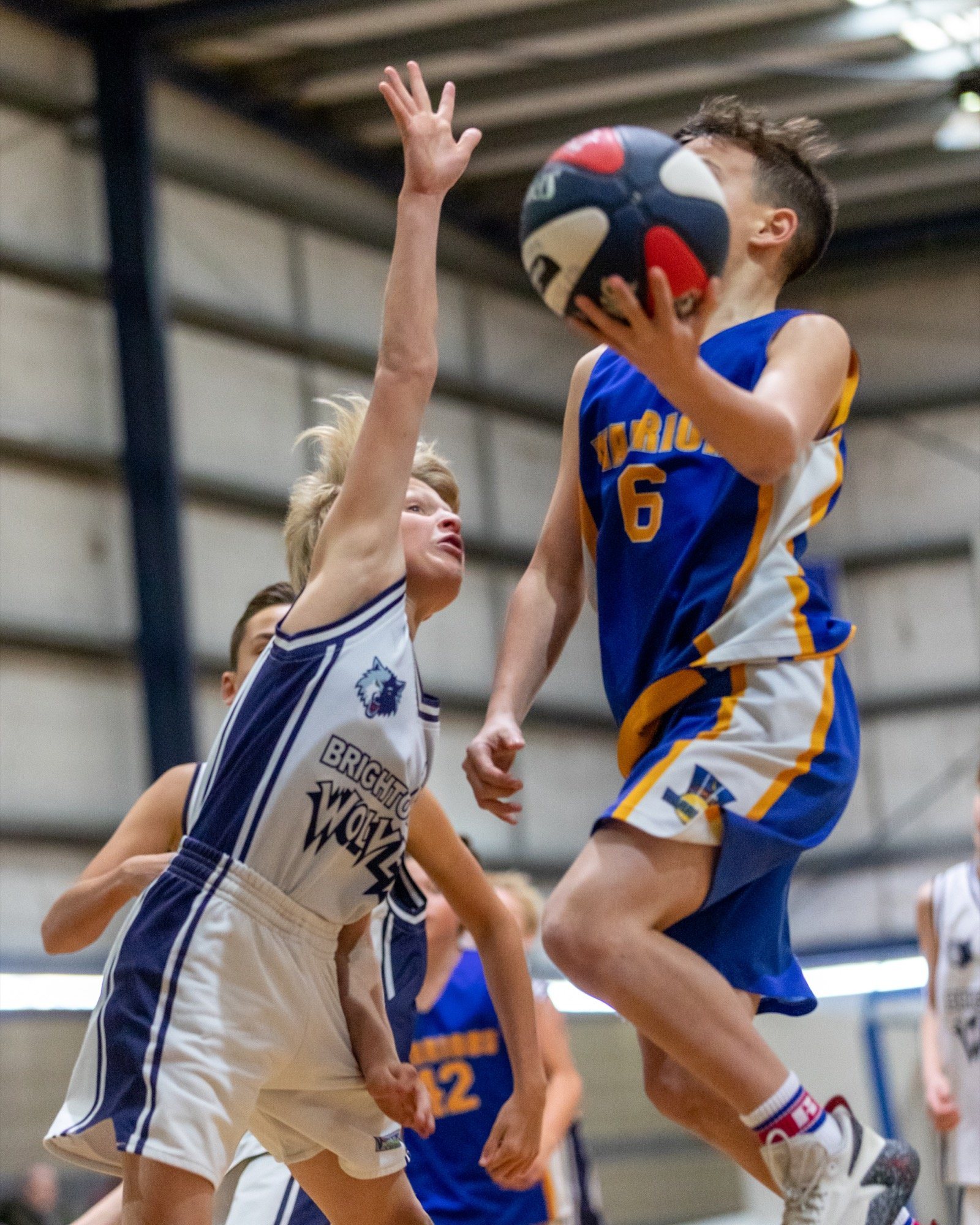 Junior player going up for a layup