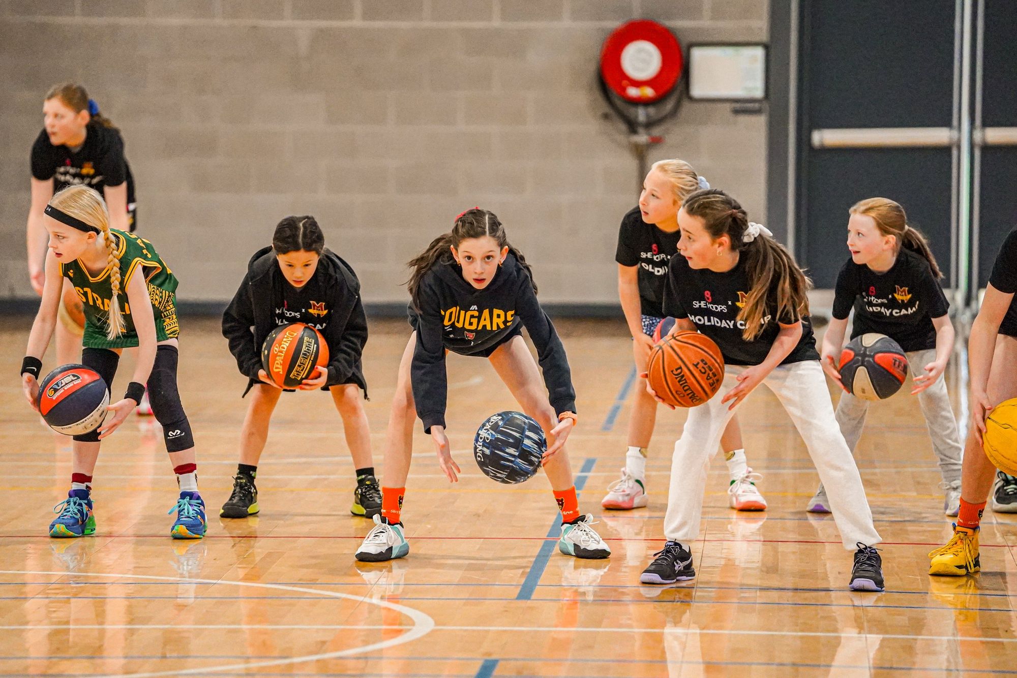 Girls dribbling at a McKinnon holiday camp