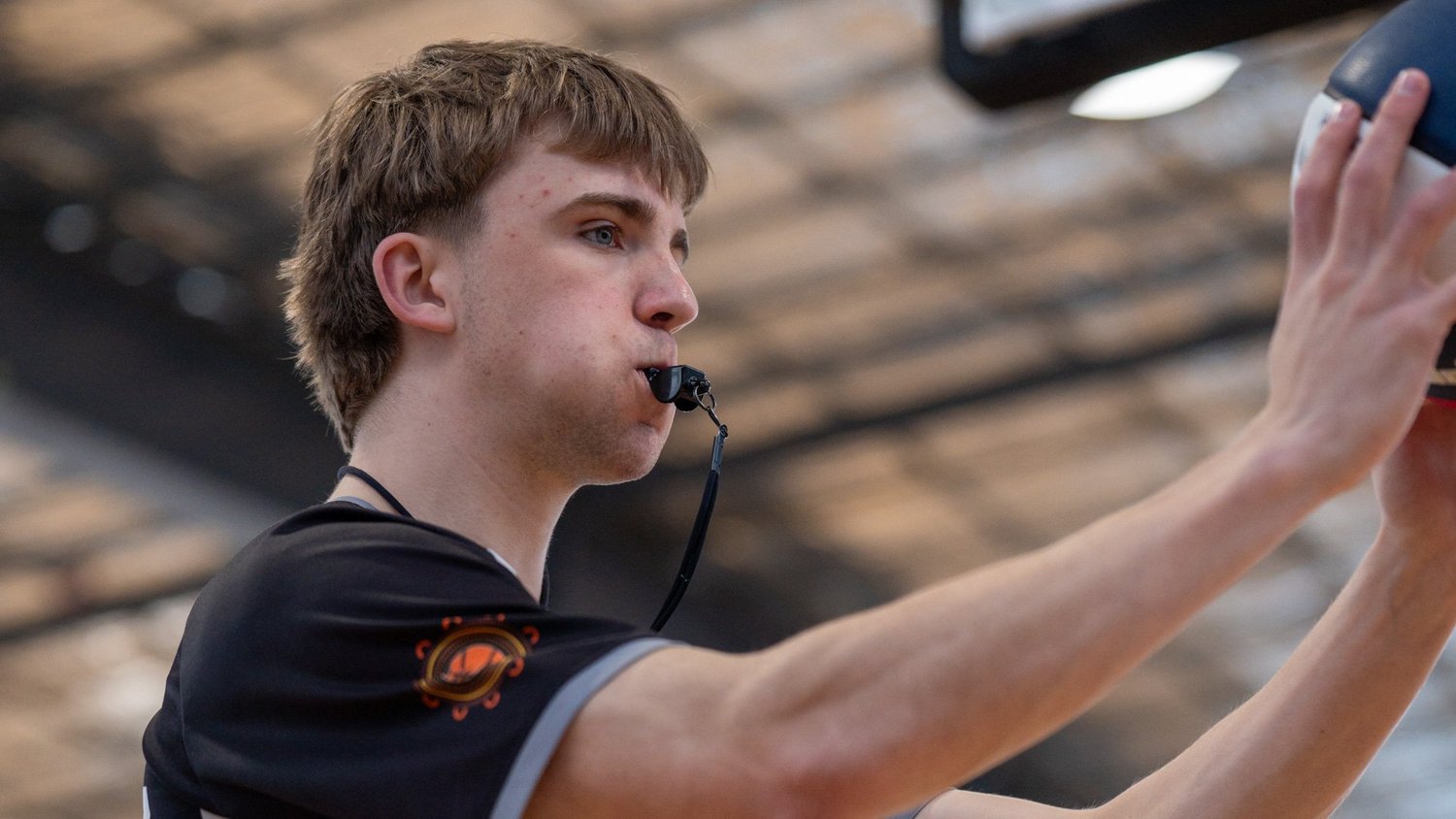A young McKinnon referee with a whistle